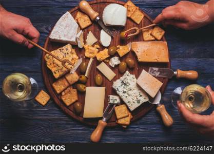 Pair have a nice evening with cheese plate and wine. The Cheese plate
