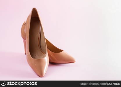 Pair of elegant high heel shoes. Pair of elegant leather high heel shoes on pink background