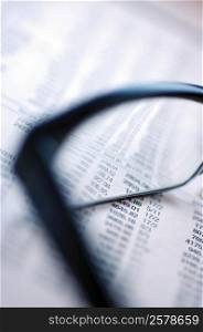 Pair of eyeglasses on a financial page