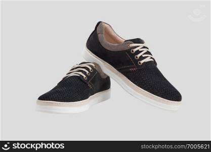 pair of fashionable leather sneakers with laces isolated on white