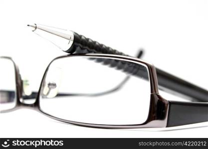 pair of glasses and a pen isolated on white