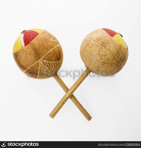 Pair of handmade Mexican maracas percussion musical instruments against white background.