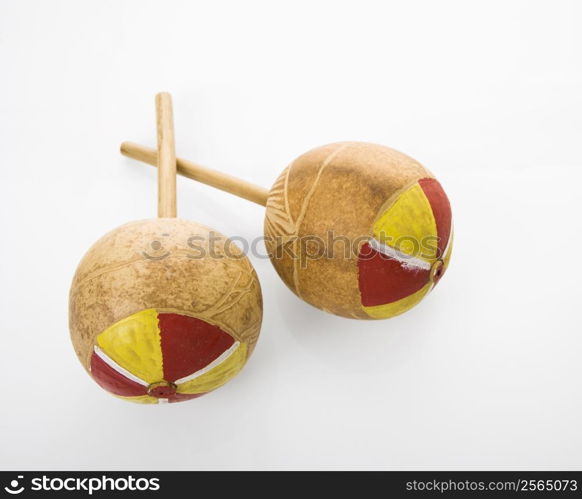 Pair of handmade Mexican maracas percussion musical instruments against white background.