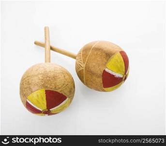 Pair of handmade Mexican maracas percussion musical instruments against white background.