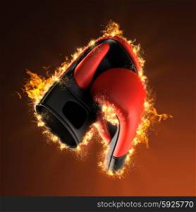 Pair of leather boxing gloves in fire
