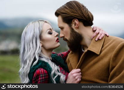 pair of lovers in the Carpathian mountains in national costumes