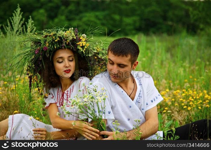 pair of man and woman. man give flowers to girl. outdoor shot