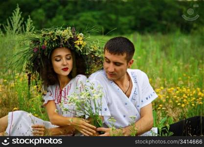pair of man and woman. man give flowers to girl. outdoor shot