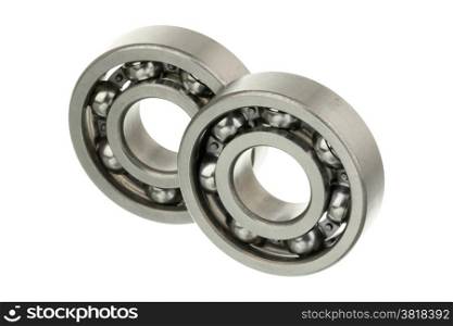 Pair of metallic bearings isolated over white background&#xA;