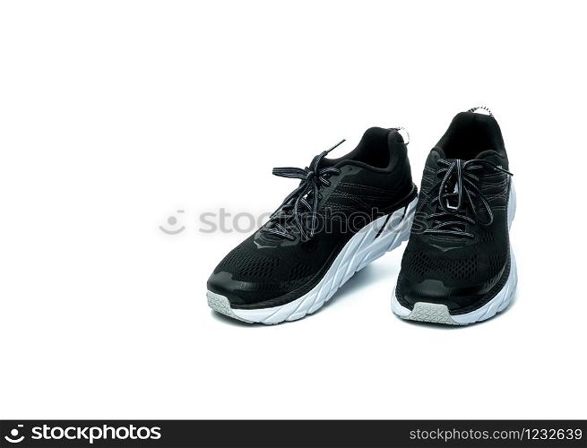 Pair of new running shoes isolated on white background. Black sneakers. Breathable fabric sport shoes with high abrasion rubber outsole. Footwear of gym trainer. Light and comfortable running shoes.