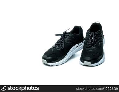 Pair of new running shoes isolated on white background. Black sneakers. Breathable fabric sport shoes with high abrasion rubber outsole. Footwear of gym trainer. Light and comfortable running shoes.