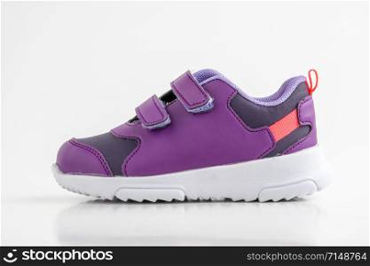 Pair of purple leather sport shoes for girls on white background. purple sport shoes
