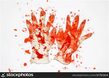 Pair of rubber gloves with blood splattered on them.