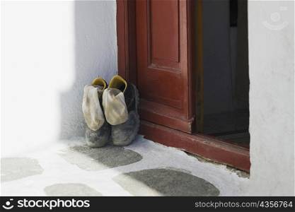 Pair of shoes at a door, Mykonos, Cyclades Islands, Greece