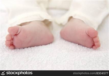 Pair of tiny newborn baby feet close up