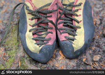 Pair of used climbing shoes on the ground&#xA;