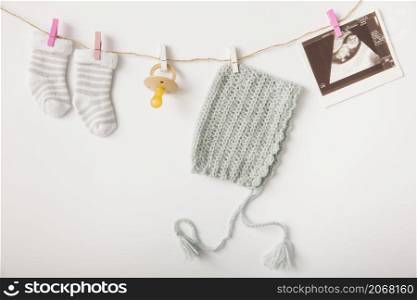 pair socks pacifier headwear sonography picture hanging string with clothes peg