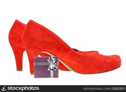 pairs of red high heel pumps with small gift box isolated on white background
