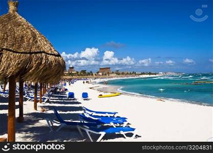 Palapas and lounge chairs on the beach, Tulum, Quintan Roo, Mexico