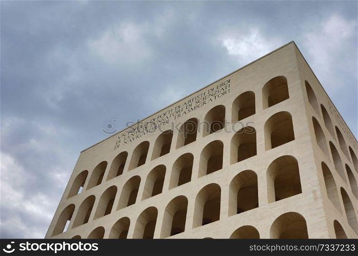 Palazzo della Civilta Italiana  Square Colosseum  in Rome, Italy. The inscription reads   A nation of poets, of artists, of heroes, of saints, of thinkers, of scientists, of navigators, of migrants 