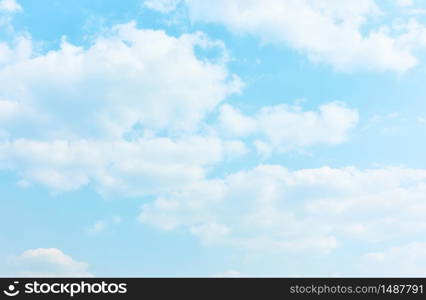 Pale blue sky with white clouds - textured background