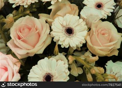 pale pink roses and white gerberas in a wedding arrangement