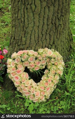 Pale pink roses on a heart shaped sympathy arrangement