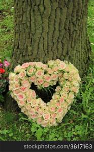 Pale pink roses on a heart shaped sympathy arrangement