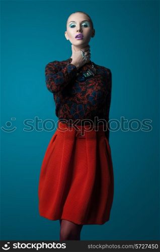 Pale woman in a red skirt on blue background