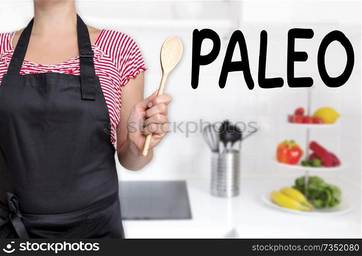 paleo cook holding wooden spoon background concept.. paleo cook holding wooden spoon background concept