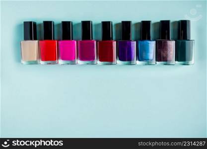 Palette of bright nail polishes on a blue background.. Palette of bright nail polishes on blue background.