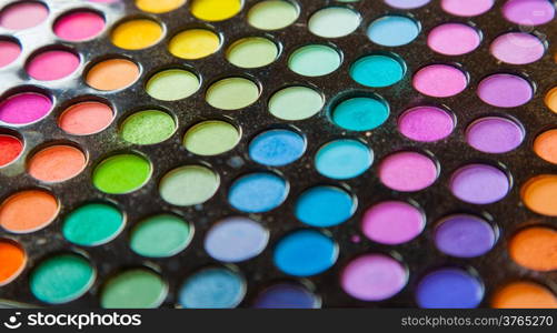 Palette of professional colorful eye shadows. Collection of multicolor eyeshadows. Cosmetology product. Makeup set background.