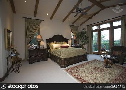 Palm Springs bedroom with beamed ceiling and patio doors