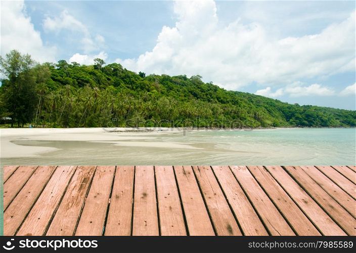 palm tree on a background of tropical turquoise sea.Wood planks floor. Beauty nature background.