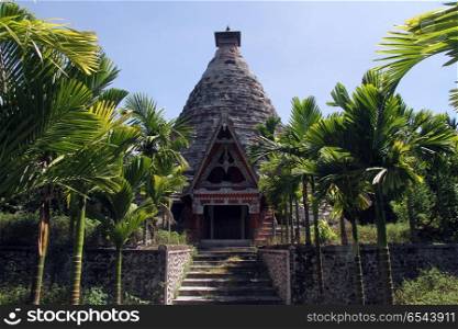 Palm trees and batak grave on the SAmosir island, Indonesia