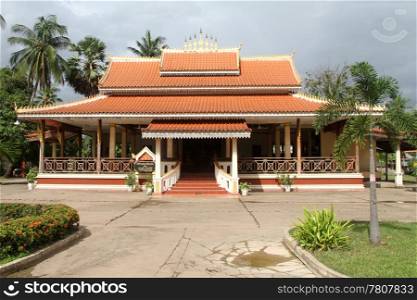 Palm trees and buddhist temple in monastery in Vientiane, Laos
