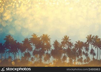 Palm trees on tropical beach, vintage toned and retro color stylized with shiny party glitter overlay effect