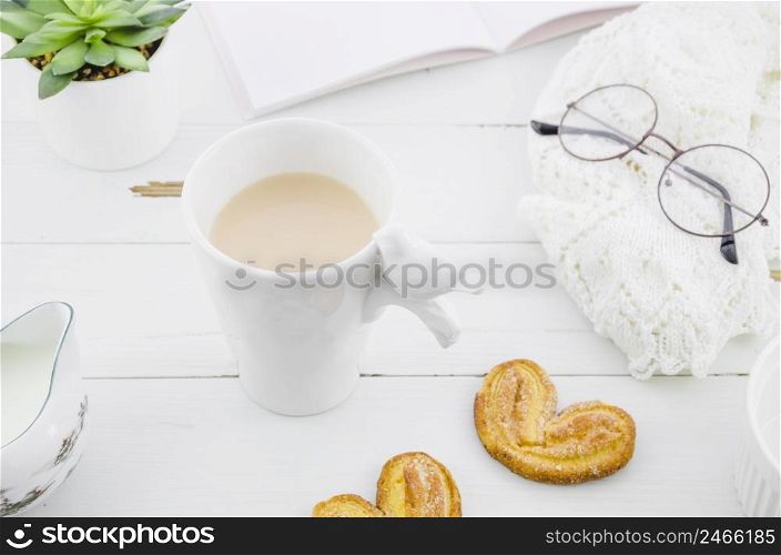palmiers puff pastry cookie with porcelain white tea cup wooden desk