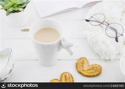 palmiers puff pastry cookie with porcelain white tea cup wooden desk