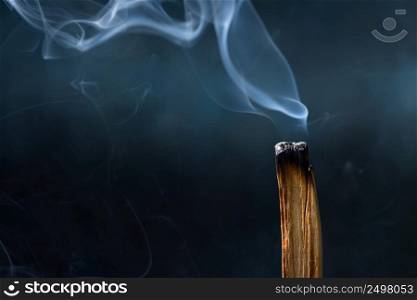 Palo Santo, Bursera graveolens, holy sacred tree stick, burning with beautiful aromatic smoke