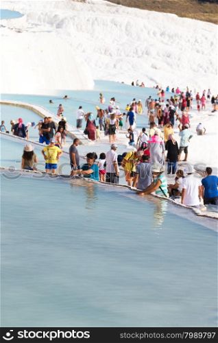 Pamukkale, Turkey - August, 14 2015: Tourists on Pamukkale Travertine pools and terraces. Pamukkale is famous UNESCO world heritage site in Turkey
