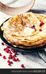 Pan cooked tasty pancakes embellished with cranberry. Cooking homemade pancakes