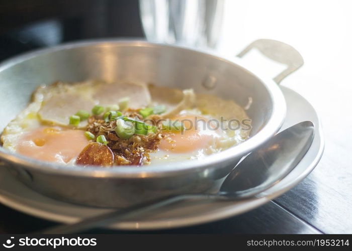 Pan - Fried Egg With Toppings, Sausages, Coriander And Onions On Top