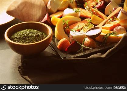 pan full of fall seasonal vegetables ready to be grilled over a dark background