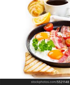 pan of fried eggs, bacon and vegetables on white background