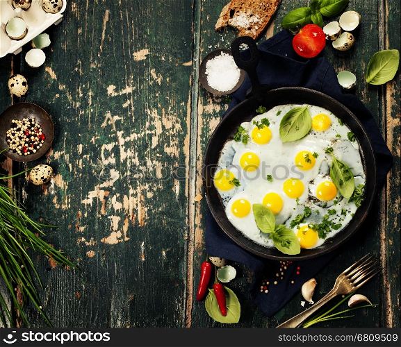 Pan of fried eggs on old green background, top view