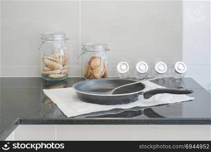 Pan on black counter top in the modern kitchen