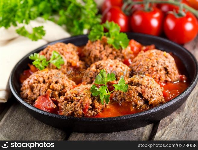 pan with meatballs on wooden table