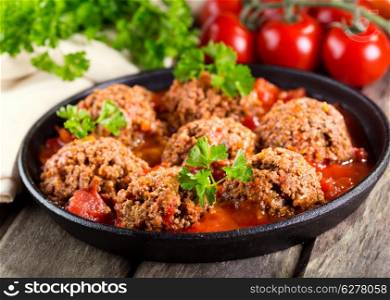 pan with meatballs on wooden table