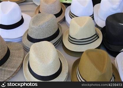 Panama hats in various colors at a market in the Provence, France